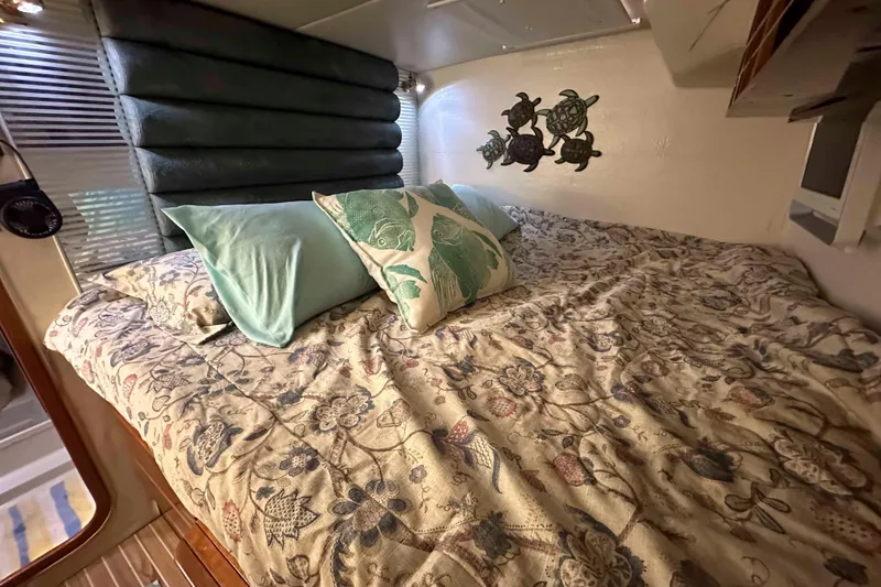 Slide: The Image of Cozy cabin bed in 1993 Jeantot Euphorie 40 yacht with floral bedding and turtle wall decor. - 10