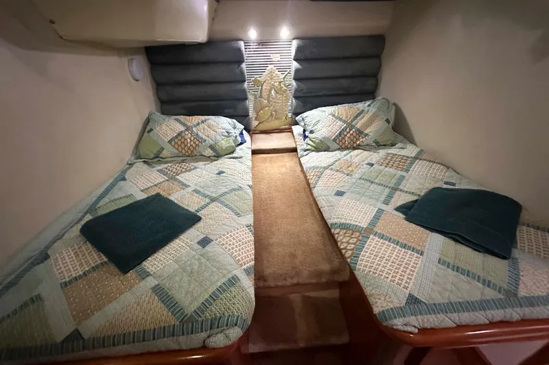 Slide: The Image of Interior cabin of 1993 Jeantot Euphorie 40 with twin beds and patterned bedding. - 13