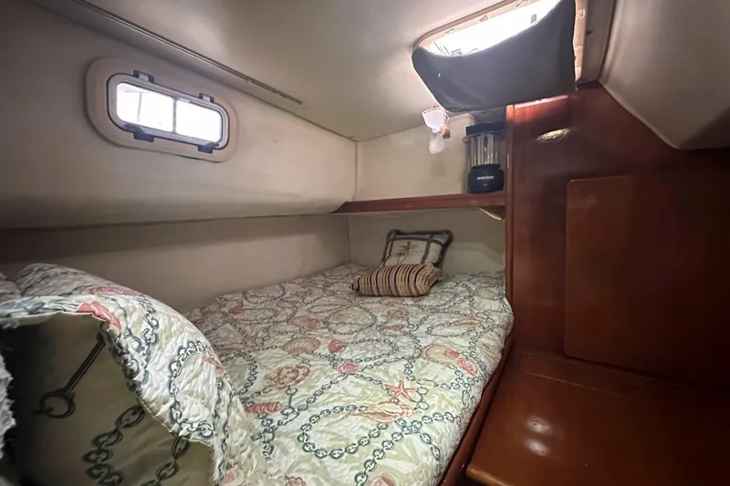 Slide: The Image of Cozy cabin interior of 1993 Jeantot Euphorie 40 with patterned bedding and wooden accents. - 16