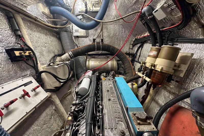 Slide: The Image of Engine room of a 1993 Jeantot Euphorie 40 yacht, showcasing mechanical components and wiring. - 22