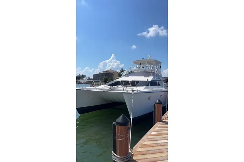 Slide: The Image of 1993 Jeantot Euphorie 40 catamaran docked under a clear blue sky. - 6
