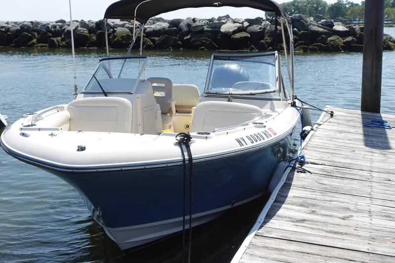 Slide: The Image of 2020 Grady-White Freedom 215 boat docked by a wooden pier. - 0