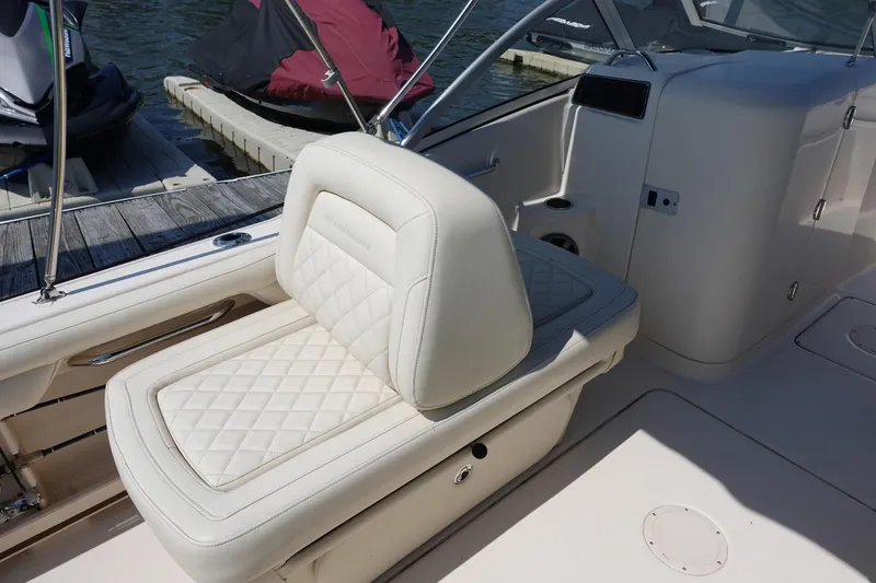 Slide: The Image of 2020 Grady-White Freedom 215 boat interior with luxurious white seating and sleek design. - 13