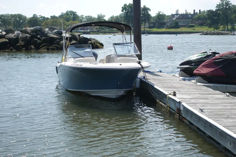 Slide: The Image of 2020 Grady-White Freedom 215 boat docked on a sunny day by the water. - 3