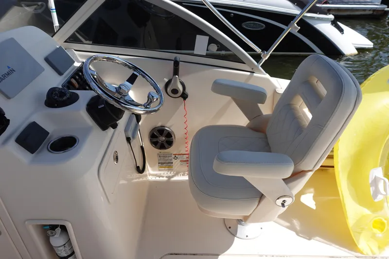 Slide: The Image of 2020 Grady-White Freedom 215 boat helm with steering wheel and captain's chair. - 5