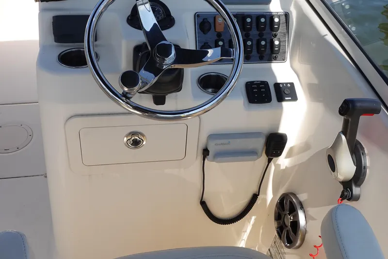 Slide: The Image of 2020 Grady-White Freedom 215 boat dashboard with steering wheel and control panel. - 7
