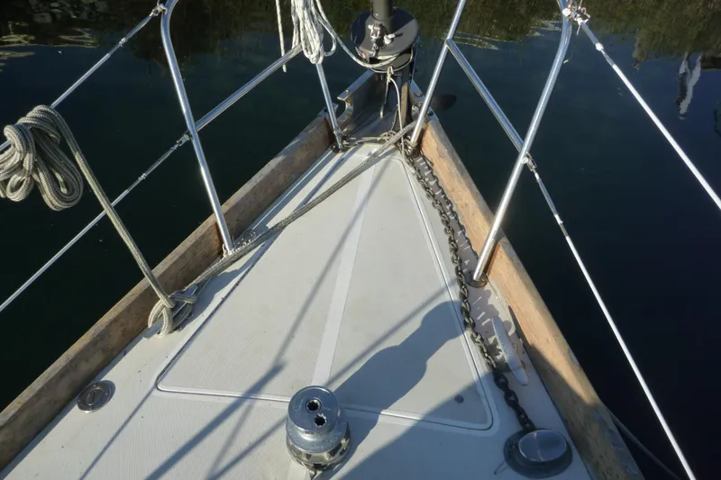 Slide: The Image of Bow of 1987 Bristol 35.5 sailboat with anchor chain and ropes. - 11