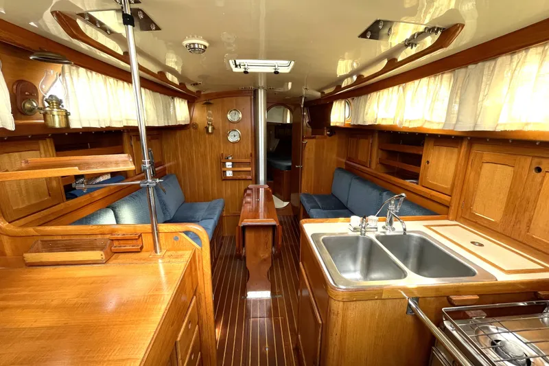 Slide: The Image of Interior of 1987 Bristol 35.5 sailboat with wooden finish and blue seating. - 15