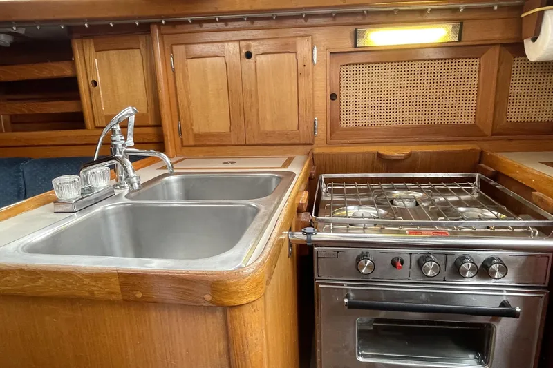 Slide: The Image of 1987 Bristol 35.5 yacht kitchen with stainless steel sink and stove, wooden cabinetry. - 19