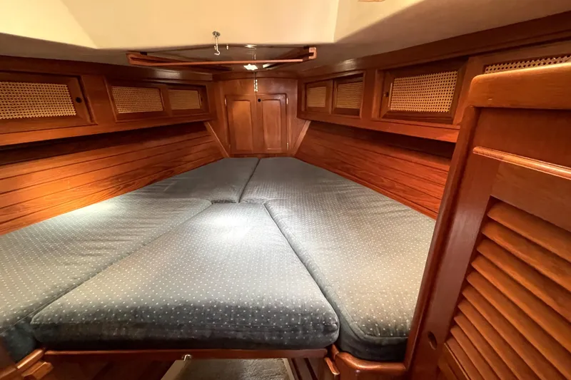 Slide: The Image of 1987 Bristol 35.5 yacht interior with cozy wooden cabin and cushioned bed. - 23