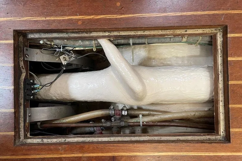 Slide: The Image of 1987 Bristol 35.5 yacht interior showing wiring and plumbing components. - 25