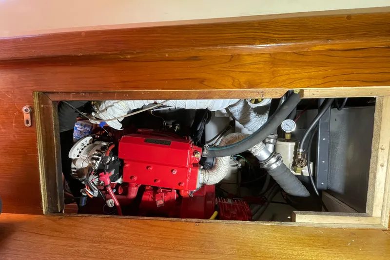 Slide: The Image of 1987 Bristol 35.5 engine compartment with red engine and wooden paneling. - 28