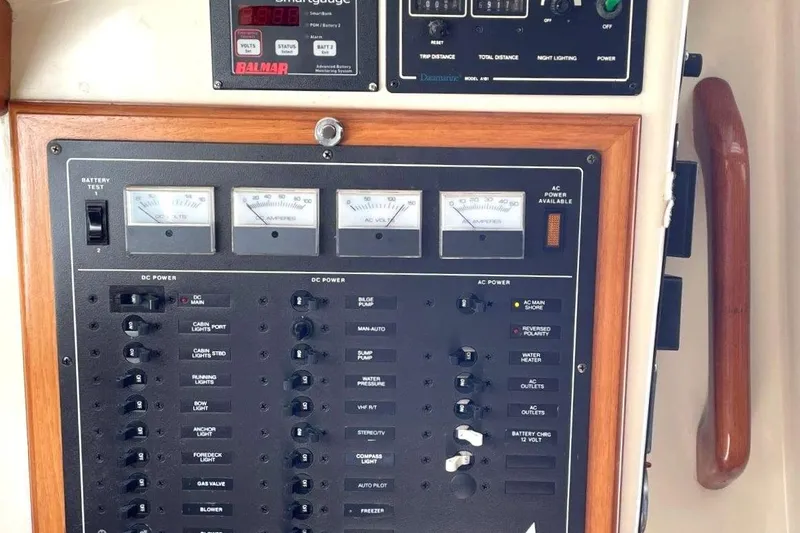 Slide: The Image of Electrical control panel on a 1987 Bristol 35.5 boat, featuring gauges and switches. - 29
