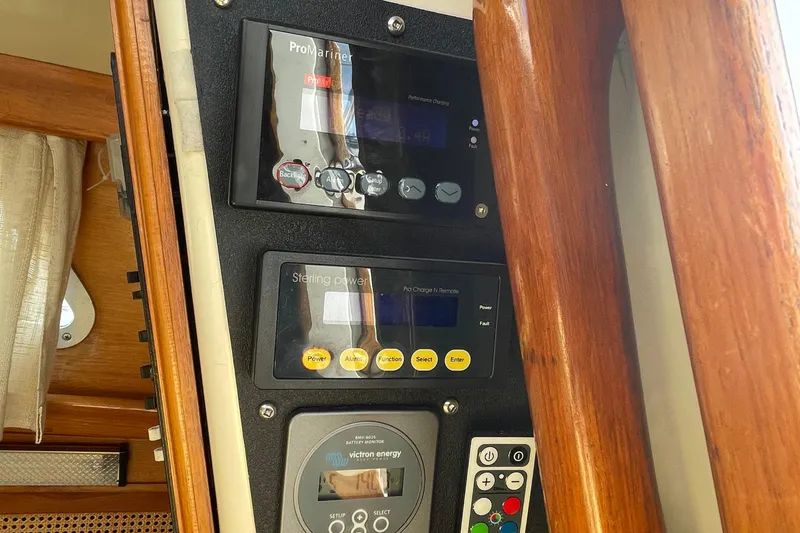 Slide: The Image of Control panel inside a 1987 Bristol 35.5 yacht, featuring ProMariner and Sterling Power displays. - 30