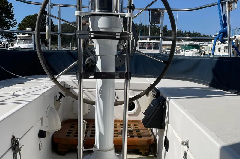 Slide: The Image of Cockpit of a 1987 Bristol 35.5 sailboat with steering wheel and nautical equipment. - 7