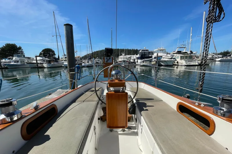 Slide: The Image of 1987 Bristol 35.5 sailboat docked in a marina, surrounded by other boats. - 8
