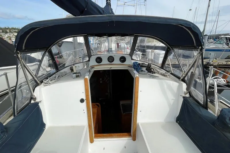 Slide: The Image of 1987 Bristol 35.5 sailboat cockpit with navy canopy, docked in marina. - 9
