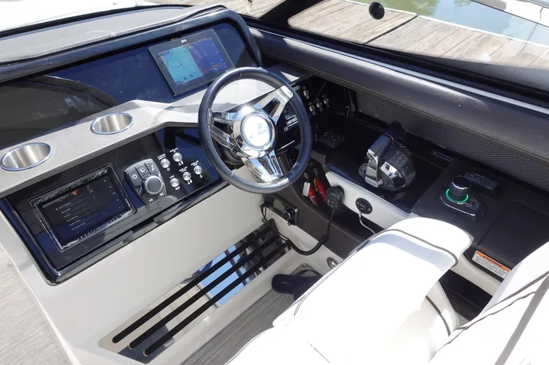 Slide: The Image of 2018 Sea Ray SLX 310 Outboard helm with modern controls and navigation displays. - 12