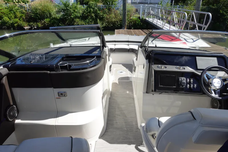 Slide: The Image of 2018 Sea Ray SLX 310 Outboard boat interior with sleek dashboard and seating. - 17