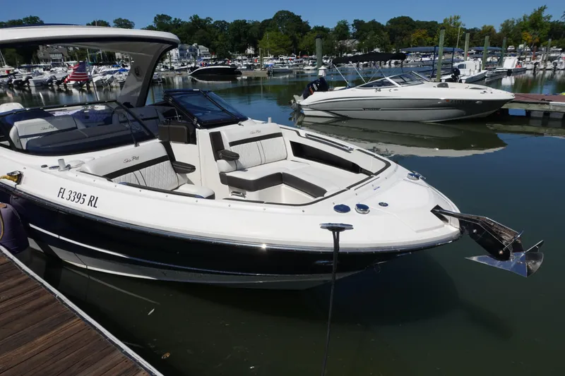 Slide: The Image of 2018 Sea Ray SLX 310 Outboard boat docked in a marina, surrounded by other boats. - 2
