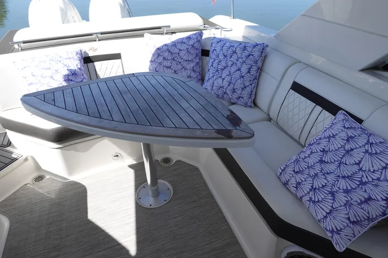 Slide: The Image of Luxurious seating area on 2018 Sea Ray SLX 310 Outboard with decorative cushions. - 20