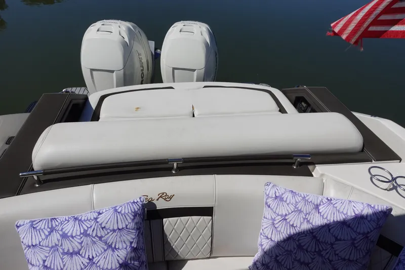 Slide: The Image of 2018 Sea Ray SLX 310 Outboard boat with twin engines and decorative cushions. - 25