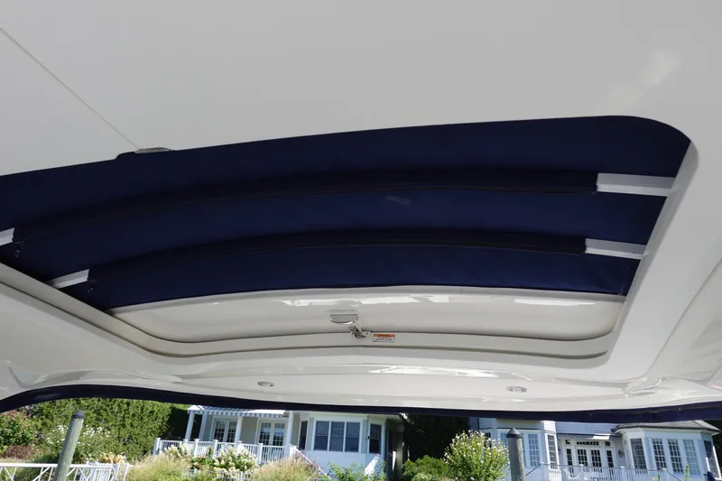 Slide: The Image of 2018 Sea Ray SLX 310 Outboard boat with blue retractable sunroof. - 26