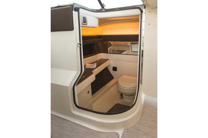 Slide: The Image of Manufacturer Provided Image: 2018 Sea Ray SLX 310 OB boat interior cabin with toilet and sink. - 28