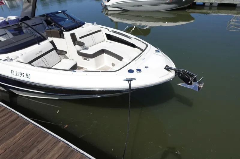 Slide: The Image of 2018 Sea Ray SLX 310 Outboard boat docked on calm water. - 3