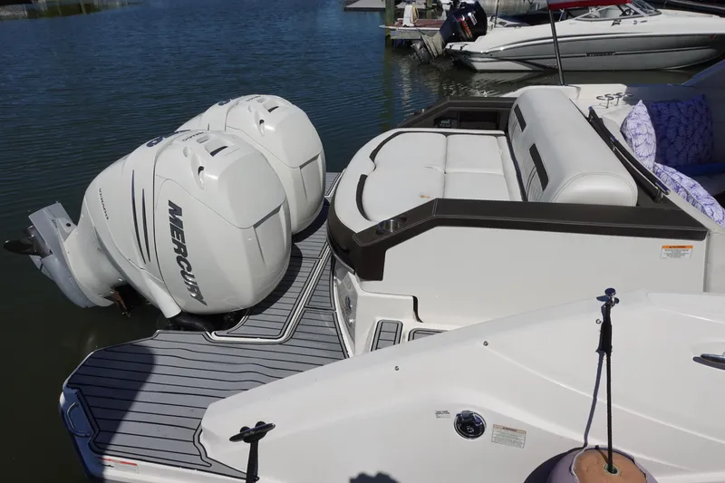 Slide: The Image of 2018 Sea Ray SLX 310 Outboard with twin Mercury engines, docked on calm water. - 5