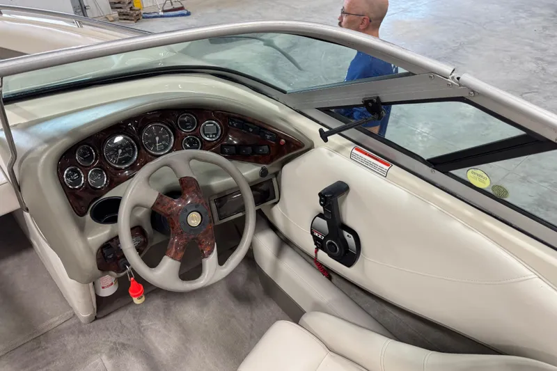 Slide: The Image of Interior view of 2000 Crownline 225 BR boat dashboard with steering wheel and controls. - 10