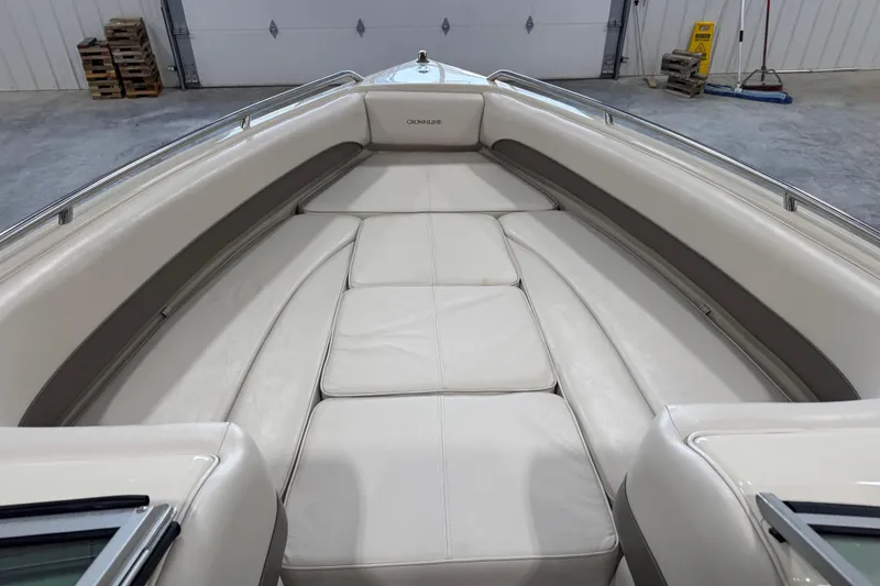 Slide: The Image of Interior view of 2000 Crownline 225 BR boat with white cushioned seating. - 11