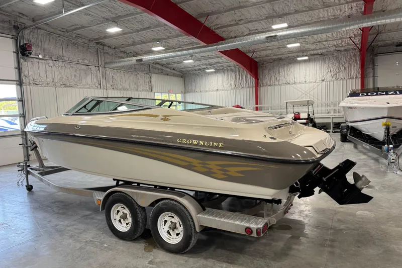 Slide: The Image of 2000 Crownline 225 BR boat on trailer in indoor storage facility. - 13