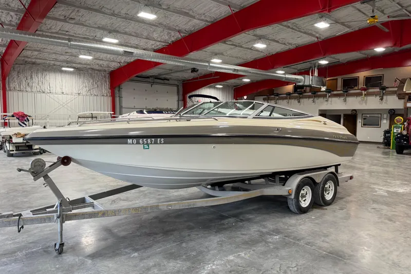 Slide: The Image of 2000 Crownline 225 BR boat on trailer in indoor storage facility. - 14