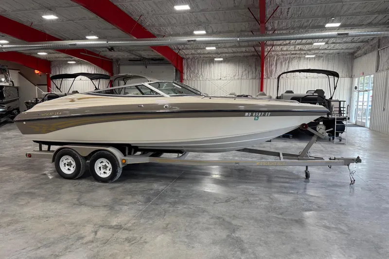 Slide: The Image of 2000 Crownline 225 BR boat on trailer in indoor showroom. - 15