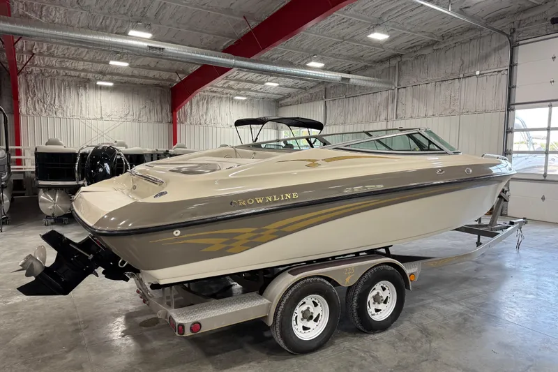 Slide: The Image of 2000 Crownline 225 BR boat on trailer in indoor storage facility. - 16