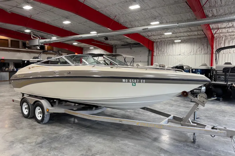 Slide: The Image of 2000 Crownline 225 BR boat on trailer in indoor showroom. - 2