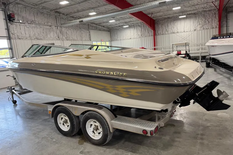 Slide: The Image of 2000 Crownline 225 BR boat on trailer in indoor storage facility. - 3