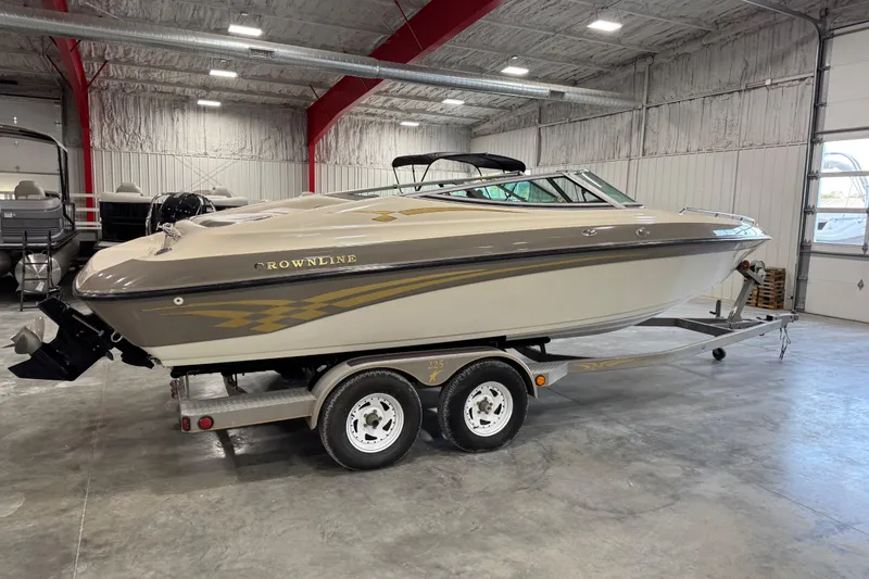 Slide: The Image of 2000 Crownline 225 BR boat on trailer in indoor storage facility. - 4