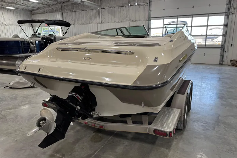 Slide: The Image of 2000 Crownline 225 BR boat on trailer in indoor storage facility. - 5