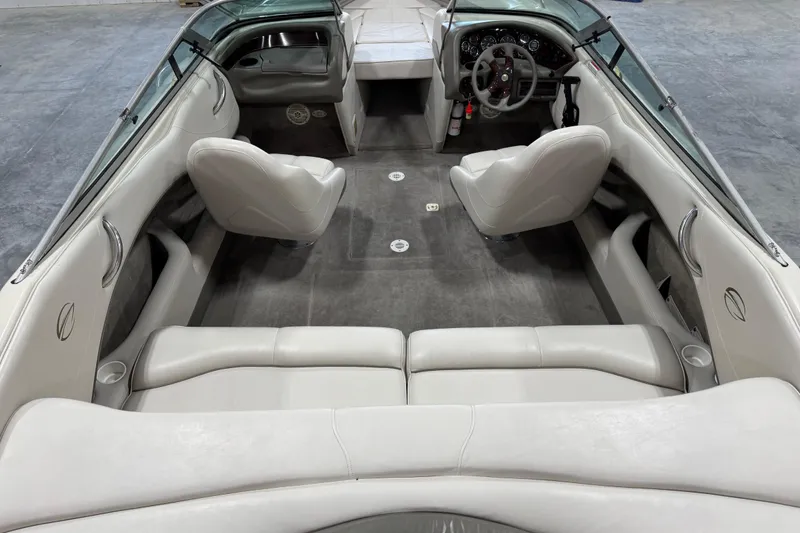 Slide: The Image of Interior of a 2000 Crownline 225 BR boat with white seating and steering wheel. - 6
