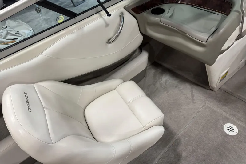 Slide: The Image of 2000 Crownline 225 BR boat interior with white leather seating and cup holder. - 8