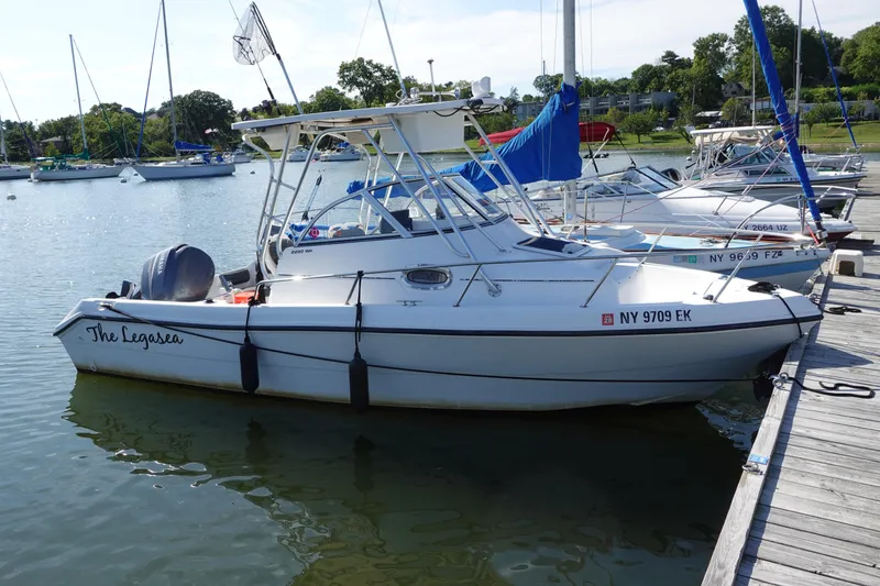 The Image of 2004 PROSPORT 2250 boat named "The Legasea" docked at a marina. - 0