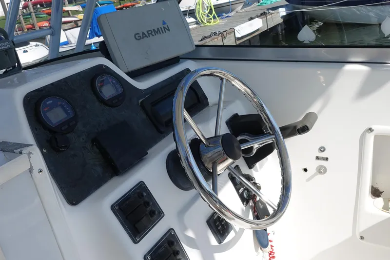 Slide: The Image of Boat steering console with Garmin GPS, Prosports 2250, 2004 model, docked at marina. - 5