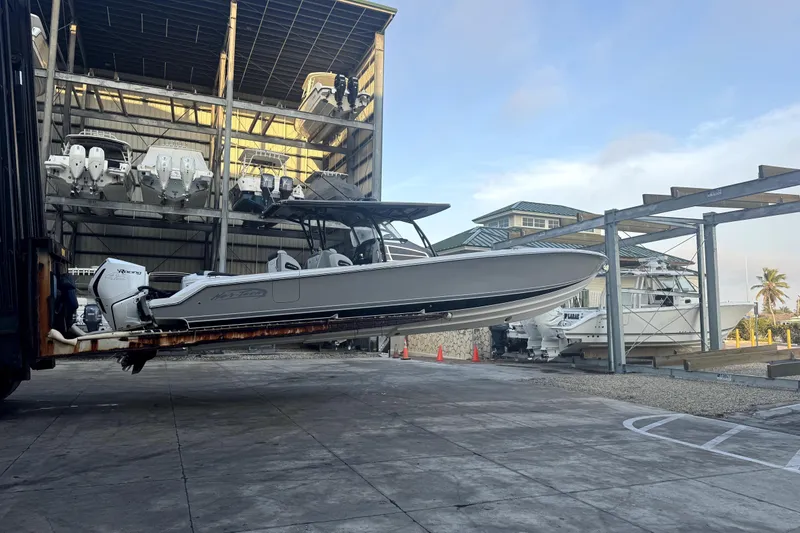 Slide: The Image of 2023 Nor-Tech 390 Sport Center Console boat in storage facility. - 3