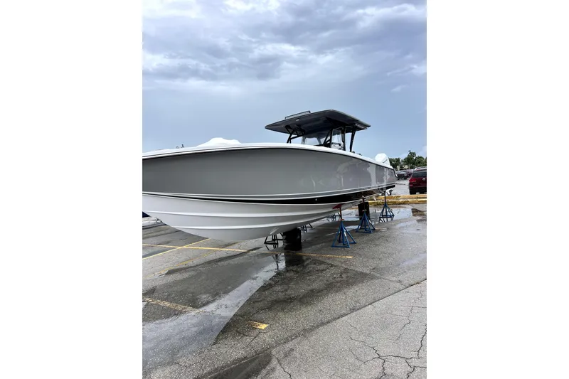 Slide: The Image of 2023 Nor-Tech 390 Sport Center Console boat on stands in a parking lot. - 4
