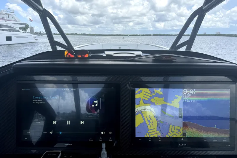 Slide: The Image of Dashboard of 2023 Nor-Tech 390 Sport Center Console with navigation and audio displays. - 8