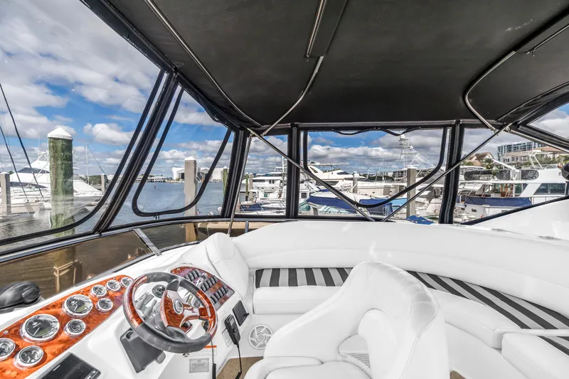 Slide: The Image of 2008 Meridian 459 Motoryacht helm with luxurious seating and marina view. - 10