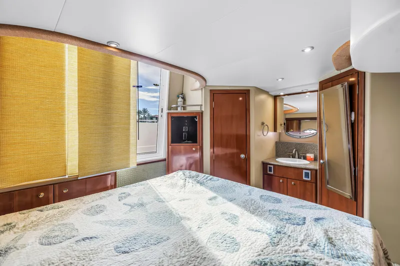 Slide: The Image of Luxurious interior of 2007 Meridian 459 Motoryacht with cozy bedroom and elegant wood finishes. - 26