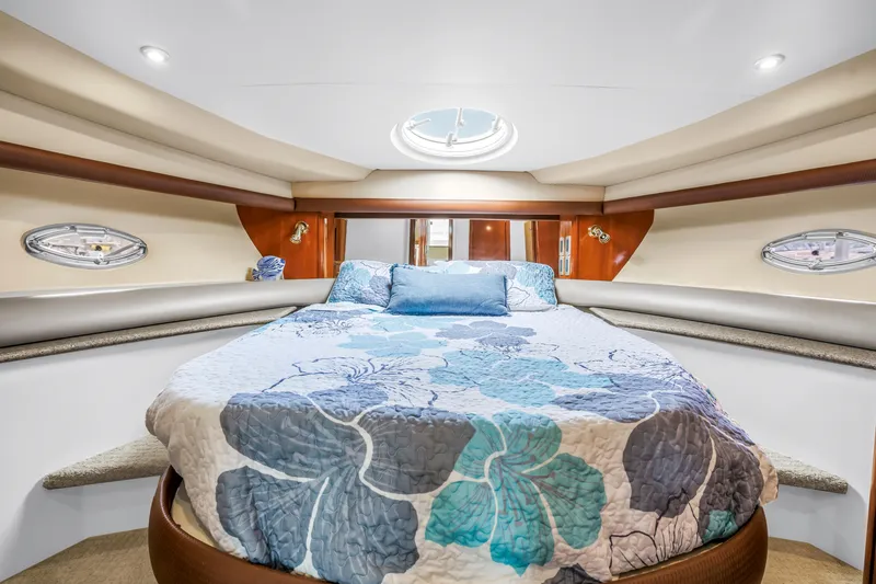 Slide: The Image of Luxurious bedroom interior of 2007 Meridian 459 Motoryacht with floral bedding and porthole windows. - 29